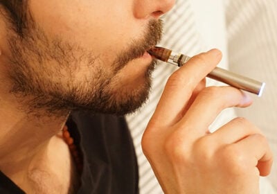 a man smoking a weed pen